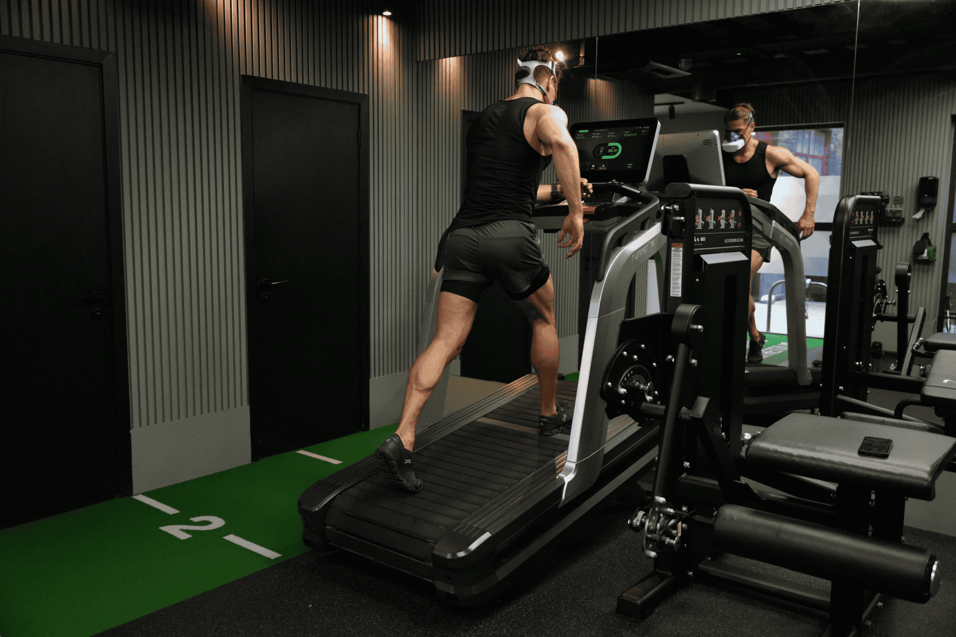 strength and fitness coach jack hanrahan conducting a bruce protocol assessment while running on a treadmill