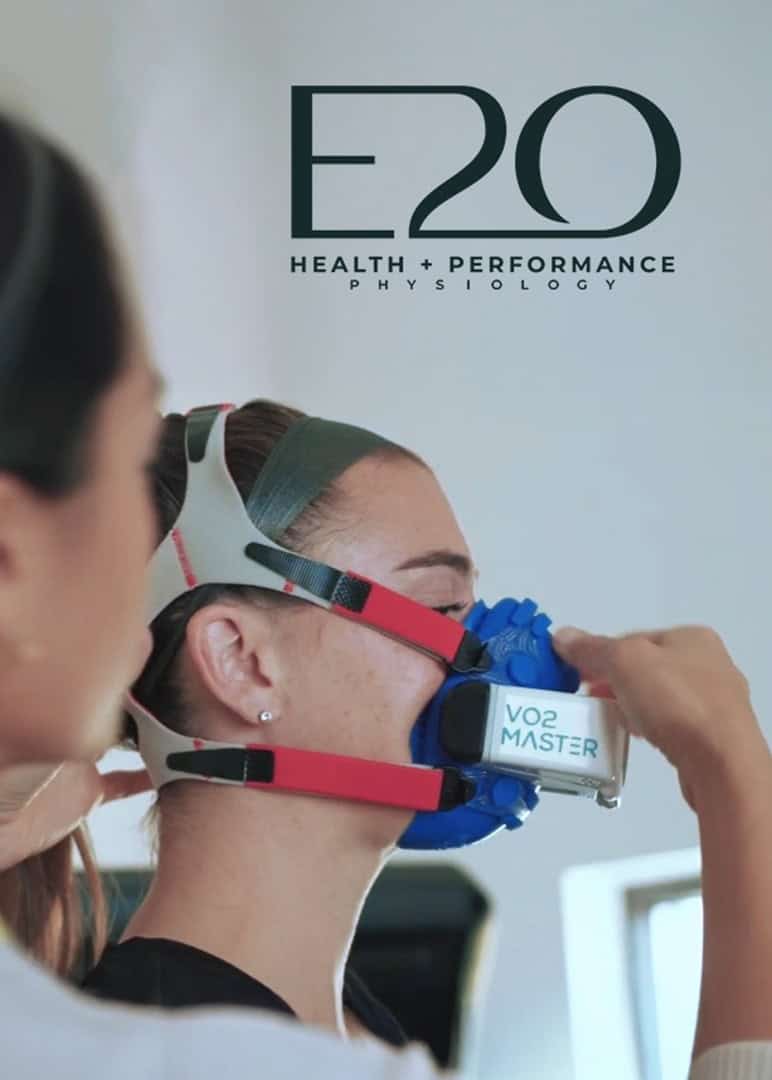 A coach helping an athlete with VO2 Master mask fitting
