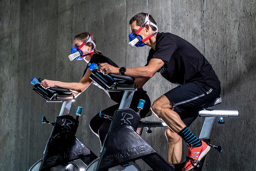 Male and female athletic stationery bikes using the blue VO2 Master analyzer and mask to measure performance