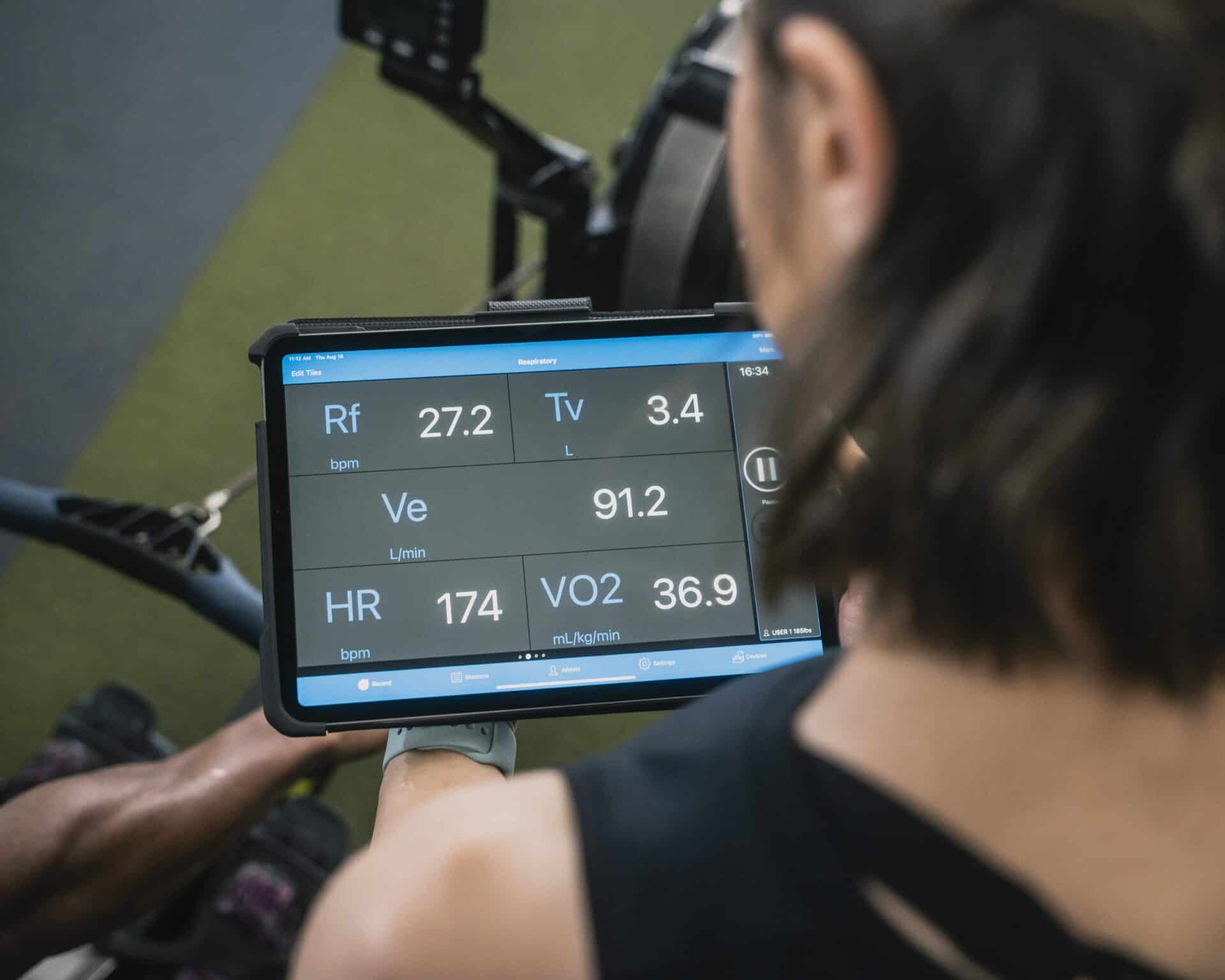 Reviewing VO2 performance data on an iPad in a fitness facility