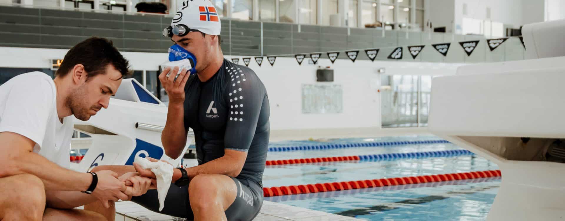 a member of the norwegian swimming olympic team is shown poolside wearing the vo2 master analyzer and tracking his training data for vt1 and vt2 and vo2 max