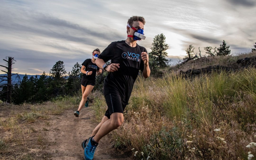 Athlete runner wearing the VO2 Master analyzer and mask outdoors, measure performance