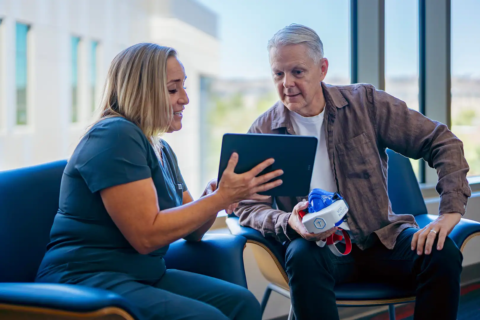 Clinician reviewing VO2 Master metabolic testing results with client in a fitness and wellness clinic.