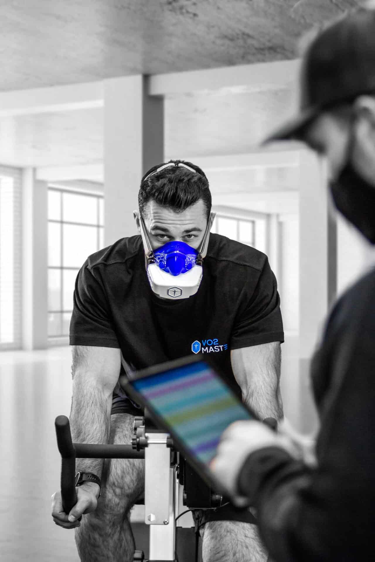Athlete training with a VO2 Master Analyzer on an exercise bike