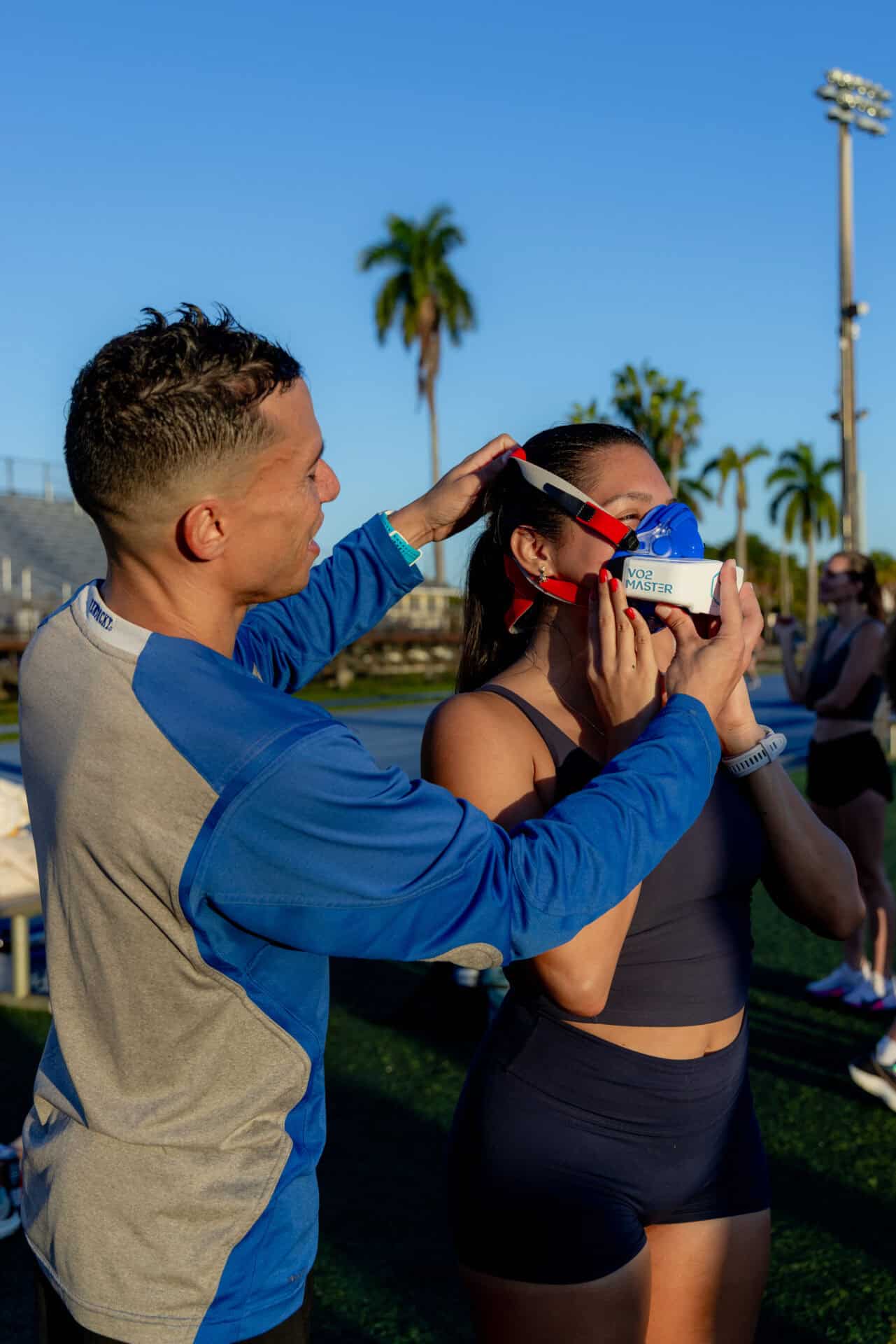 Trainer with coach fitting a VO2 Master Analyzer