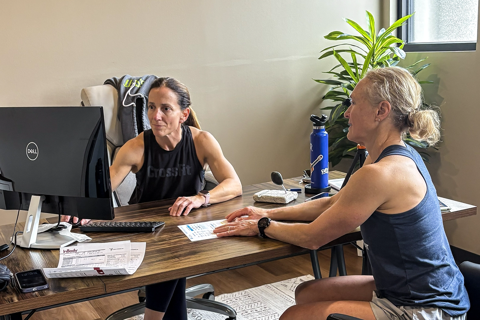 Dr. Dotti Watson reviewing VO2 Master metabolic testing results and client progress after an RMR testing session.