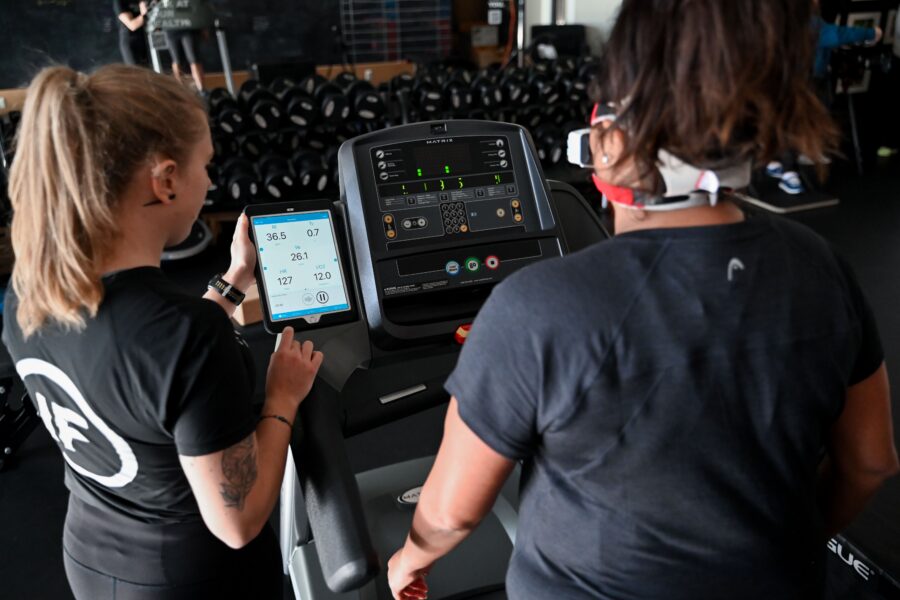 Coach conducting a VO2 Master treadmill assessment with a member at Innovative Fitness