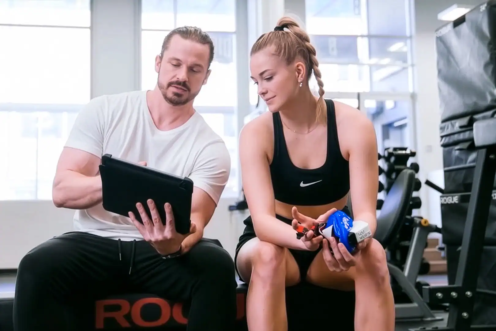 Trainer reviewing metabolic testing data with client to personalize fitness and wellness programs