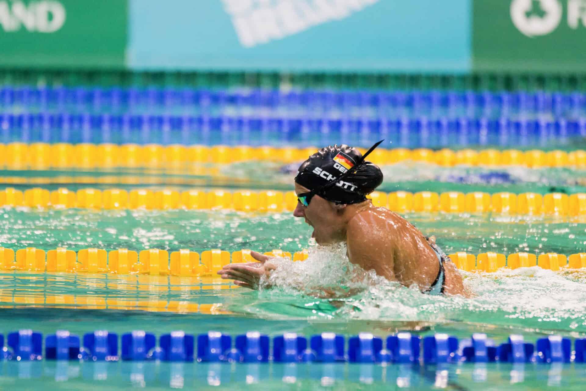 Verena Schott shown competing in an event.  She is shown doing the breast stroke.