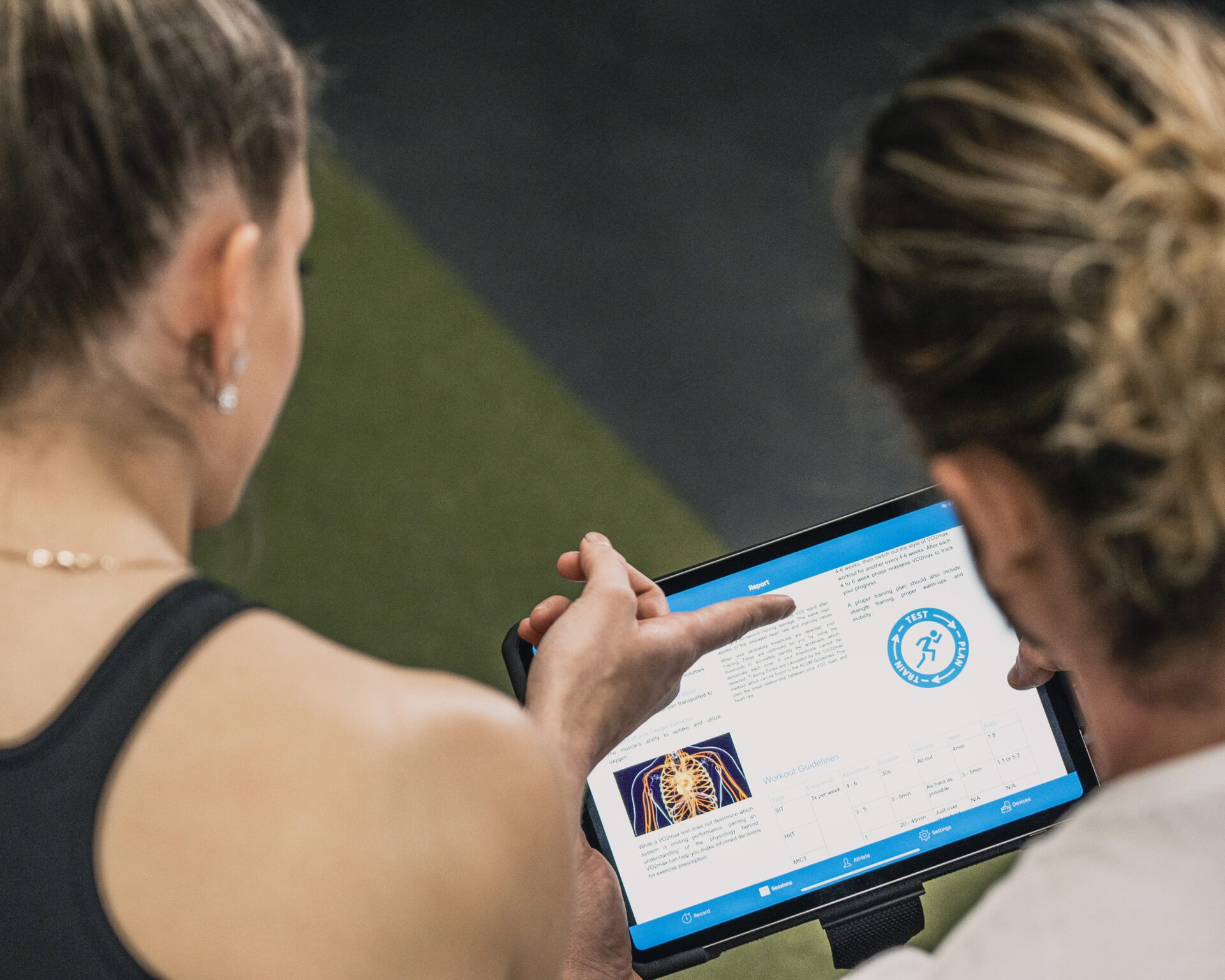 Athletic woman reviewing performance testing results on an Ipad