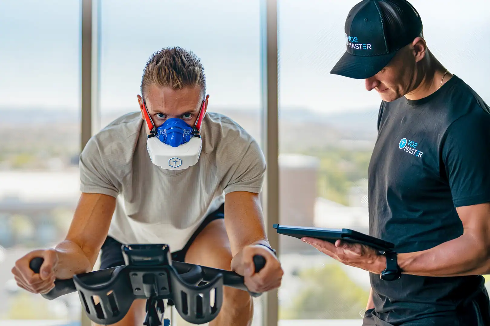 Athlete completing VO2 max testing on a bike using the VO2 Master solution with coach guidance
