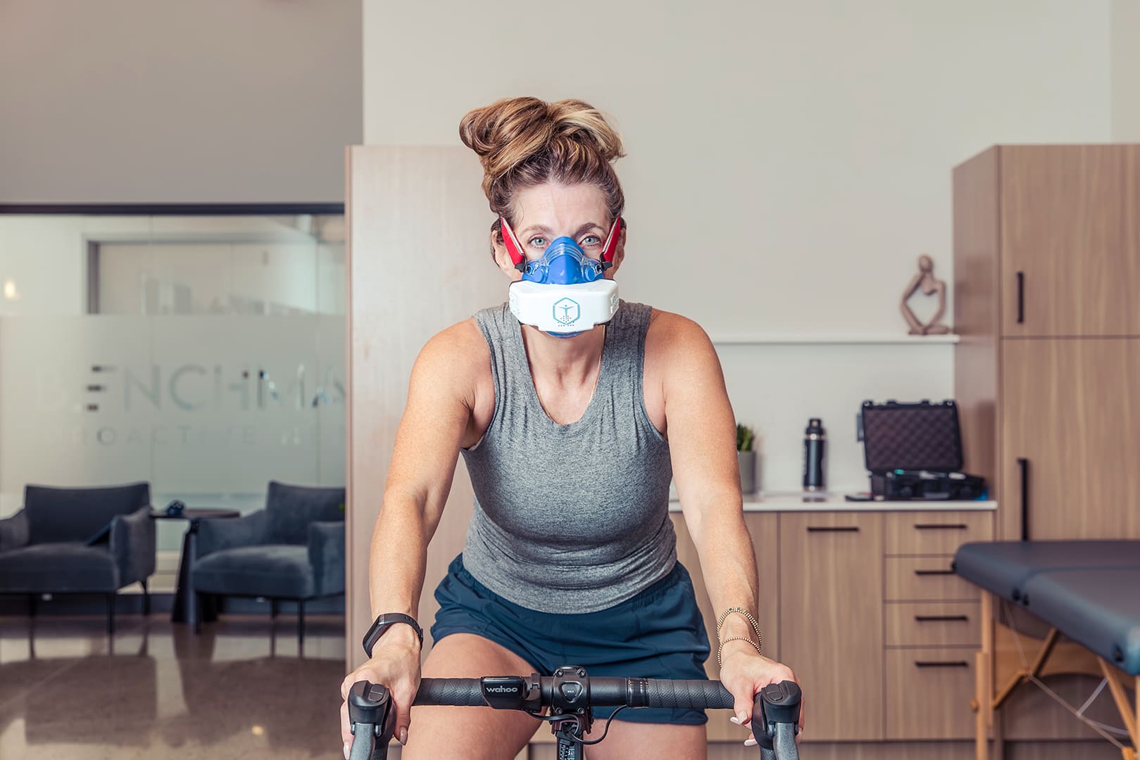 Woman over 40 completing a VO2 Max test on a stationary bike with the VO2 Master analyzer.